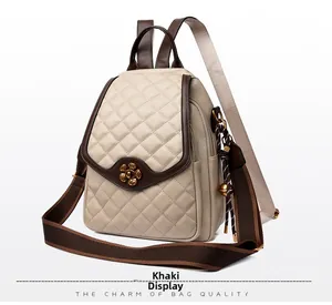 Detail view of khaki quilted leather backpack with gold plum flower lock and brown trim