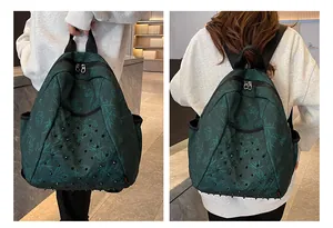 Detail of dark green floral backpack featuring punk style black rivets and side pockets