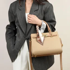 Elegant beige leather handbag with textured finish, gold twist lock and printed scarf