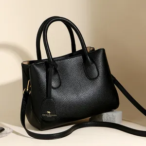 Elegant black pebbled leather tote handbag with gold kangaroo pendant and top handles