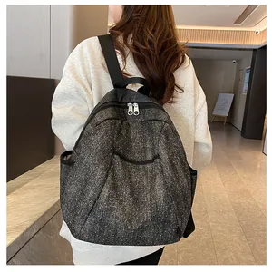 Detailed back view of a punk denim backpack with star textures and metallic studs
