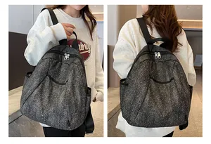 Close-up of the grey denim backpack featuring starry texture and durable shoulder straps