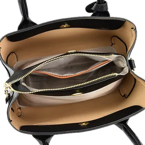 Black pebbled leather handbag with multi-compartment interior and gold hardware detail