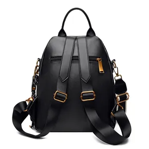 Black quilted faux leather anti-theft backpack with gold hardware and top handle