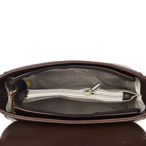Dark brown leather box bag interior with three compartments and herringbone lining
