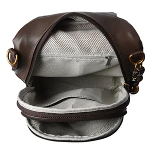 Dark brown leather backpack with quilted pattern and dual compartments in herringbone lining