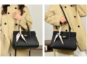 Detail of black leather handbag with gold twist lock and floral silk scarf wrapped on handle