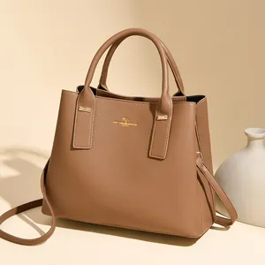 Elegant light brown genuine leather bucket handbag with gold hardware and shoulder strap