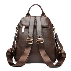 Mochila vintage de cuero encerado marrón oscuro con herrajes dorados y correas