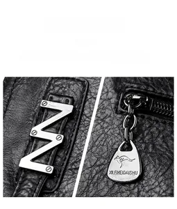 Detail of polished silver hardware and embossed logo on black pebbled leather tote bag