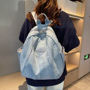 Vintage light blue denim backpack with punk studs and star pattern on model