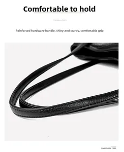 Detail of the genuine leather tote bag handle with lychee texture and double stitching