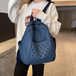 Retro denim backpack with punk rivets and quilted pattern shown by model outdoors