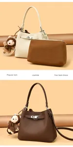 Macro detail of cowhide bucket bag with litchi texture and silver buckle lock