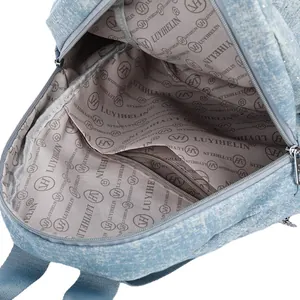 Interior view of vintage denim backpack with logo lining and functional compartments