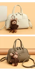 Detailed view of Boston bags in cream and brown with lychee pattern and bear charm