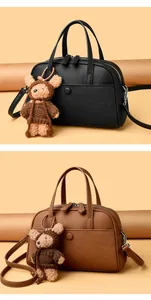 Litchi pattern Boston bag in black and brown colors with a cute plush bear pendant