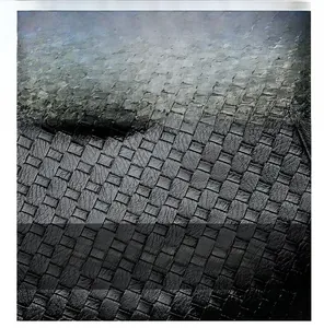 Close-up of the black woven leather texture and square intrecciato pattern on the handbag