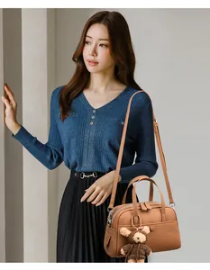 Brown lychee leather Boston bag detail with round buckle and cute plush bear charm