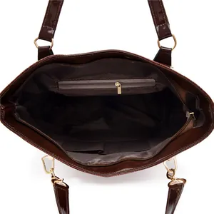 Dark brown patent leather tote bag with crocodile pattern and functional interior pockets