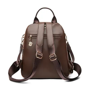 Dark brown matte suede backpack with adjustable straps and golden kangaroo pendant