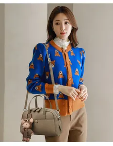 Boston bag in pebble grain leather styled with a blue teddy bear knit cardigan and pants