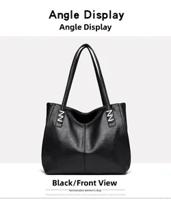 Detail of lychee pattern leather and Z-shaped silver metal buckle on black tote bag