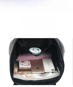 Interior view showing the large capacity and pockets of a black woven leather tote bag