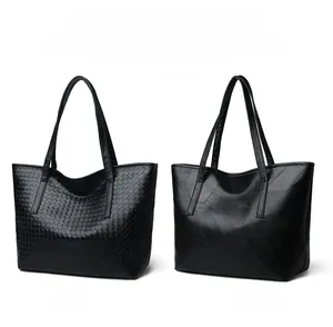 Detail view of black woven style and patchwork style faux leather tote bags