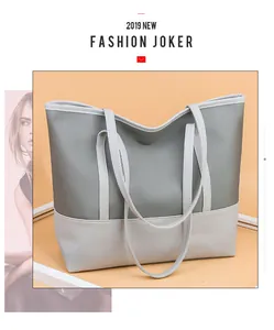 Dettaglio della grande borsa tote in oxford con nylon grigio e cuciture in pelle crema