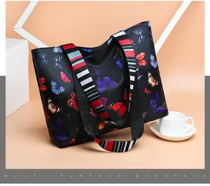 Macro detail of waterproof black nylon tote bag with colorful butterfly prints and strap
