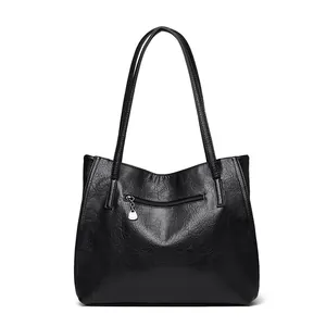 Minimalist black leather tote bag with retro texture and zipper detail for women