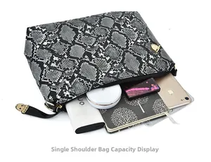 Capacity display of snake pattern shoulder bag showing phone, notebook and makeup essentials