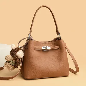 Brown lychee leather bucket bag with silver lock and cute plush bear charm