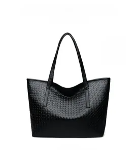 Front view of black woven tote bag with large capacity and soft faux leather texture
