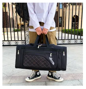 Macro detail of black quilted sports travel bag with reinforced handles and Sports text