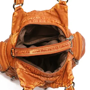 Vintage brown washed leather handbag showing multiple interior compartments and zippers