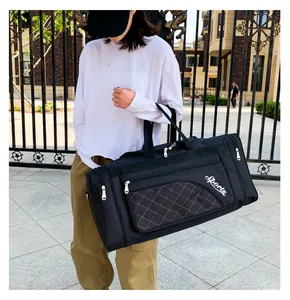 Detail of black sports travel bag with quilted brown pocket and multi-zipper compartments