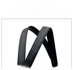 Detail of ergonomic handles on black woven leather tote showing fine stitching