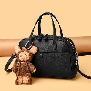 Litchi pattern Boston leather handbag in black with cute bear pendant and shoulder strap