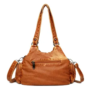 Vintage washed faux leather shoulder bag in tan with multiple pockets and bronze hardware