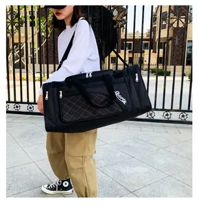 Macro detail of black quilted duffel bag featuring brown stitching and Sports logo
