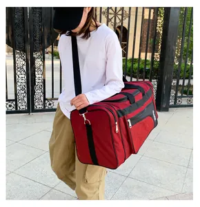 Detailed side view of a burgundy quilted travel bag with reinforced straps and metal hooks