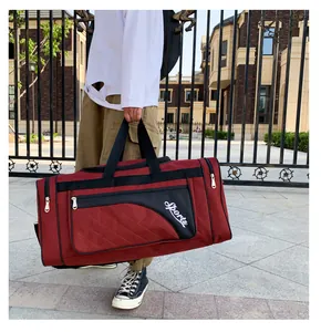 Detail of burgundy quilted fitness bag showing large capacity and sports lettering