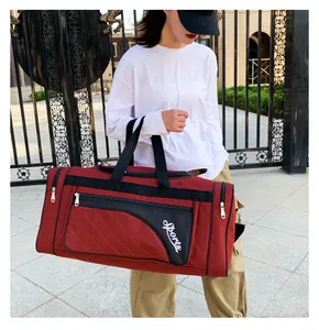 Close-up of quilted pattern and Sports logo on burgundy fitness travel bag