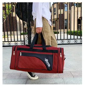 Close-up of burgundy quilted fitness bag with black straps and Sports lettering