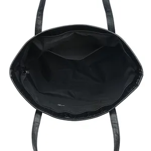 Woven black leather tote bag with internal zipper pocket and spacious lining