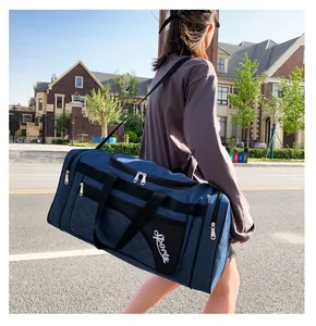 Detail of dark blue quilted gym bag with orange stitching and white Sports lettering