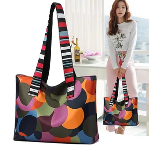 Women's large oxford tote bag with colorful polka dot pattern and striped woven handles