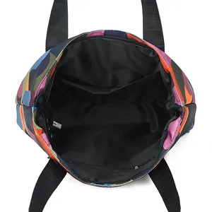 Spacious Oxford fabric tote bag with colorful camo print and secure zipper closure